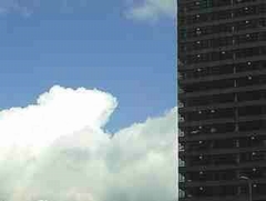 clouds and tall rise building