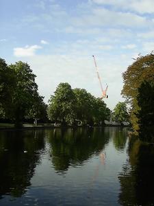 Tower crane reflected in lake