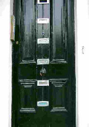 Front door of a house with six letter boxes