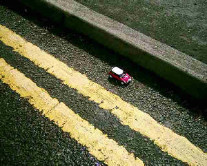 A little dinkie car parked on double yellow lines