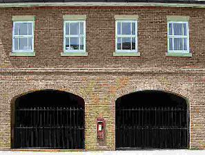 Small post box set into wall of buildings