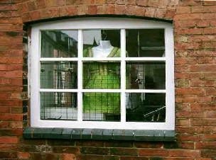A shop window with a green dress in the window