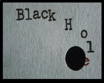 The typewritten words Black Hole dissapearing into a hole punched in the paper