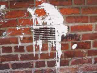 Ventilator in wall covered in white paint