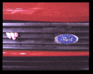 A Ford Fiesta car's bonnet with painted woman's fingers poking out