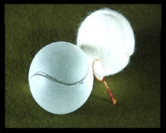 tennis ball with glass ball  too and two tiny tennis rackets
