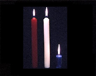 Three red white and blue candles, the blue one burnt down.